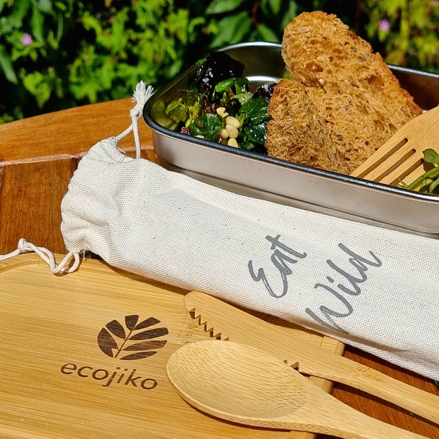 Eco-friendly bamboo cutlery set with 'Eat Wild' pouch, perfect for van life, picnics, and outdoor adventures.