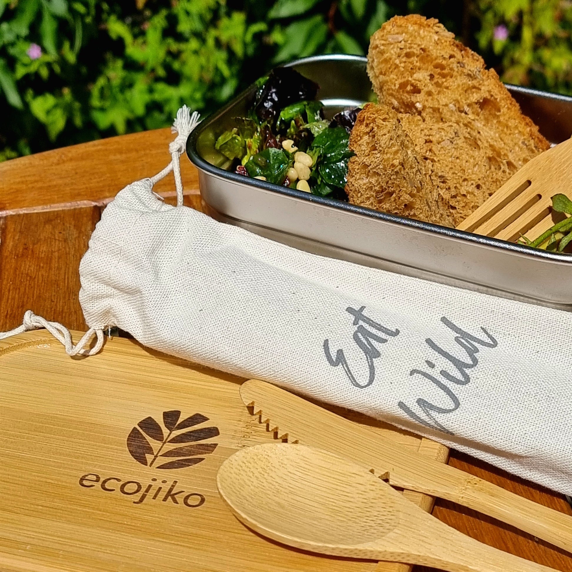 Eco-friendly bamboo cutlery set with 'Eat Wild' pouch, perfect for van life, picnics, and outdoor adventures.