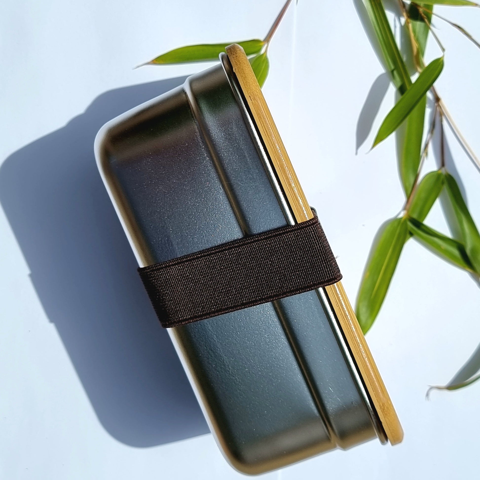 Sleek grey van life bento box with bamboo lid and strap, perfect for camper van meals and outdoor adventures.