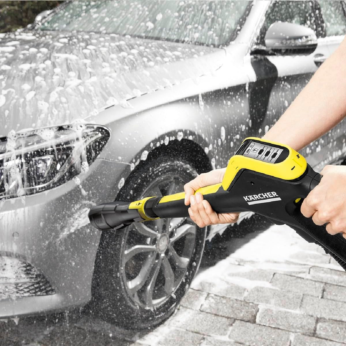 Kärcher pressure washer cleaning soapy car outdoors, van life essential for mobile adventures