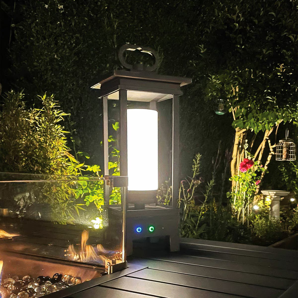 Outdoor lantern with warm glow beside modern fire pit on deck, perfect for van life camping nights