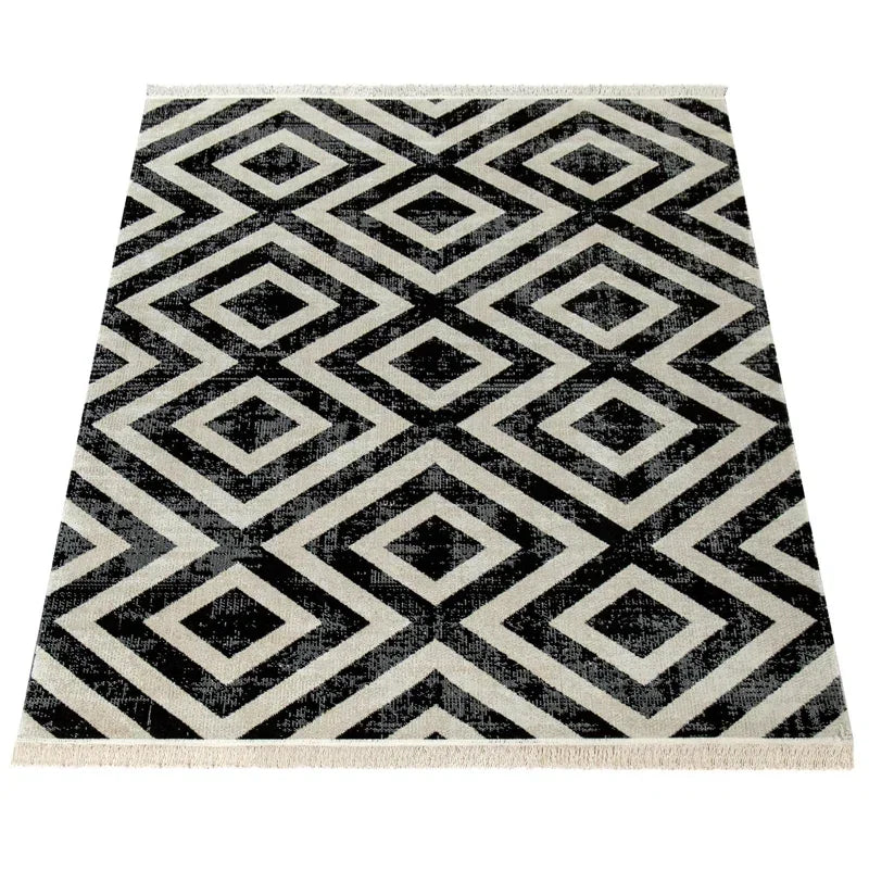 Black and white geometric rug with diamond pattern, ideal for van life interiors and camper van decor
