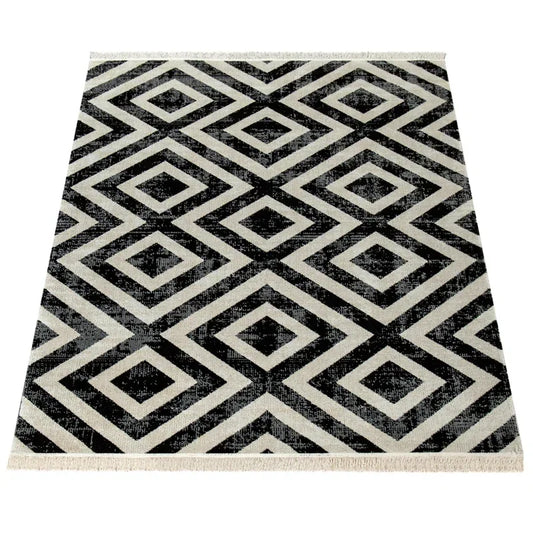 Black and white geometric rug with diamond pattern, ideal for van life interiors and camper van decor