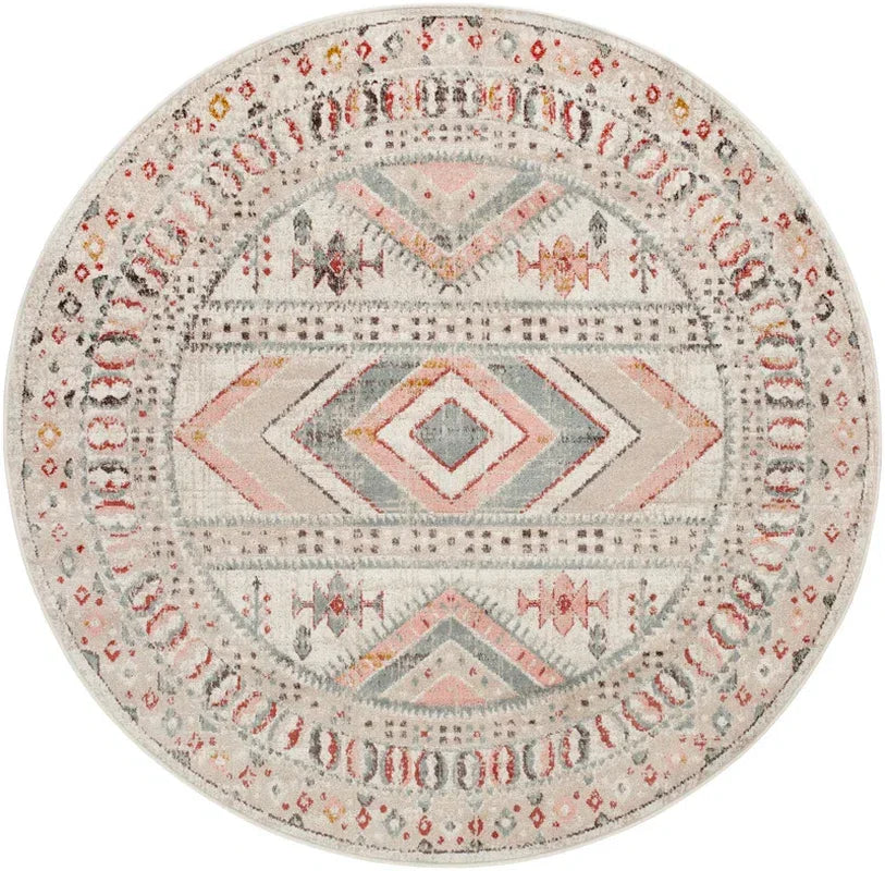Round boho rug with pink, gray & orange tribal patterns for van life or camper interior decor