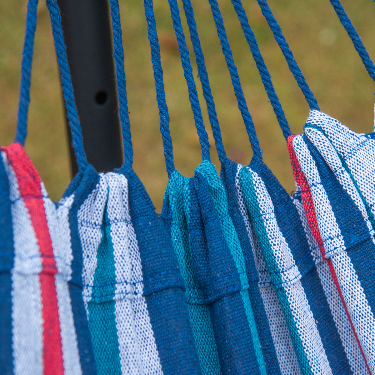 Striped hammock with blue ropes, perfect for van life adventures and outdoor relaxation