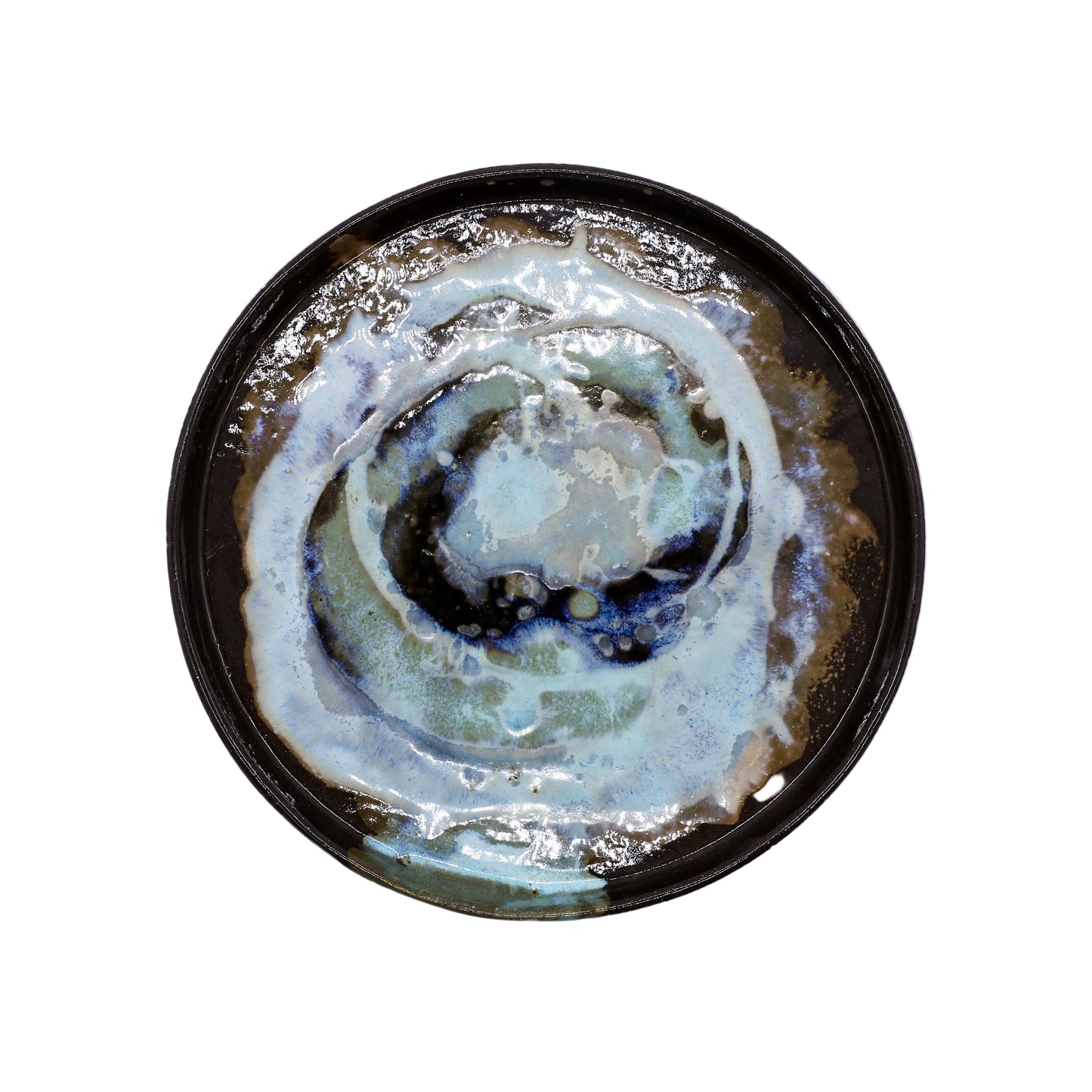 Handcrafted ceramic plate with swirling blue, white, and brown glaze, perfect for van life dining essentials.