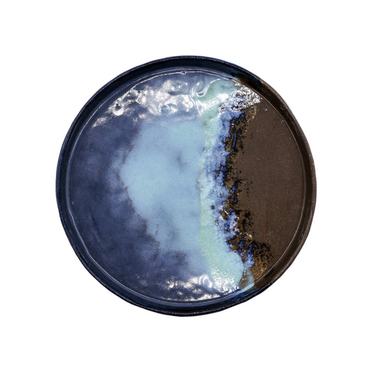 Handcrafted ceramic plate with blue, green, and brown glaze for van life camping kitchen