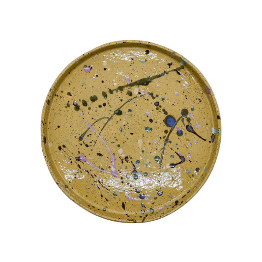 Hand-painted speckled ceramic plate with colorful splatter design, perfect for van life and outdoor adventures.
