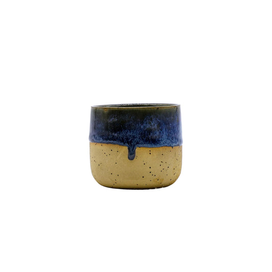 Handmade ceramic mug with blue drip glaze, perfect for van life adventures and outdoor camping gear essentials.