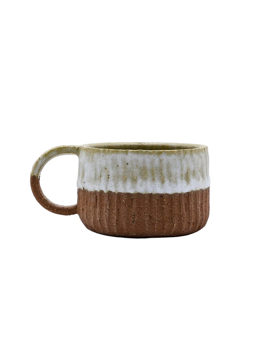 Rustic ceramic mug with ribbed texture, perfect for van life adventures and outdoor camping gear essentials.