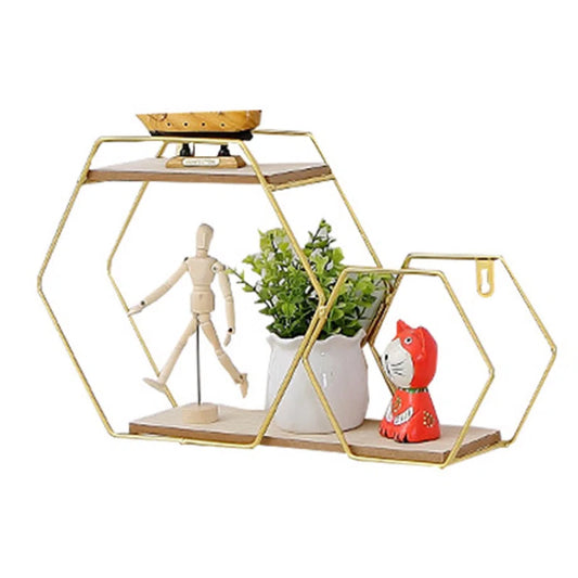 Gold hexagon wall shelf with wooden tiers, holding plant, figurine, and art for van life decor