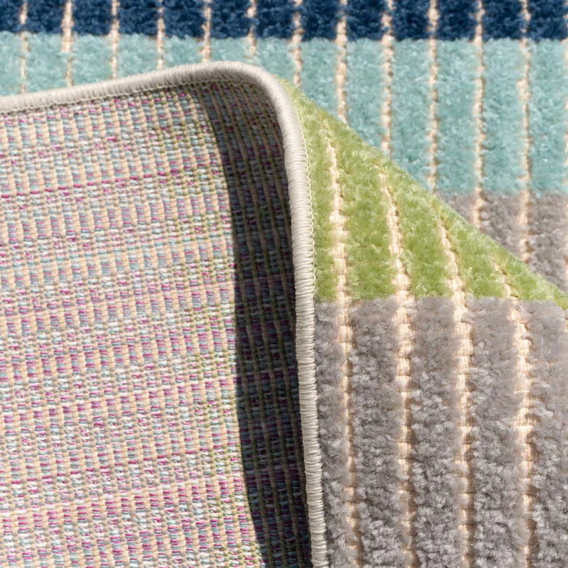 Colorful striped camper van rug with durable woven backing, perfect for van life adventures and outdoor gear setups.