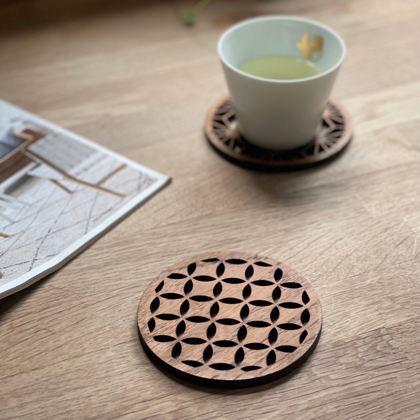 Wooden laser-cut coasters with flower of life design, perfect for van life or campervan interiors