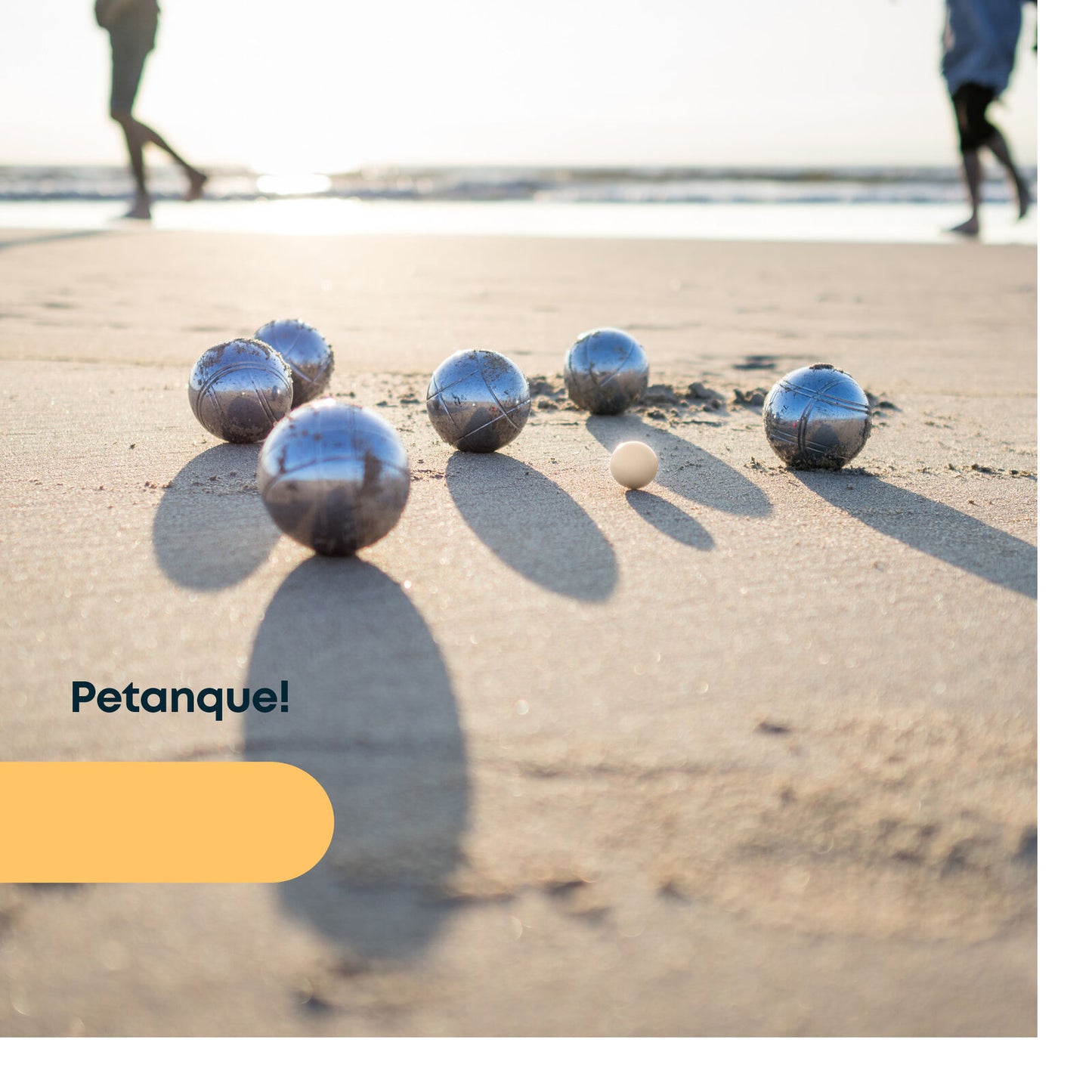 Petanque balls on sandy beach, perfect for van life outdoor games and beach adventures