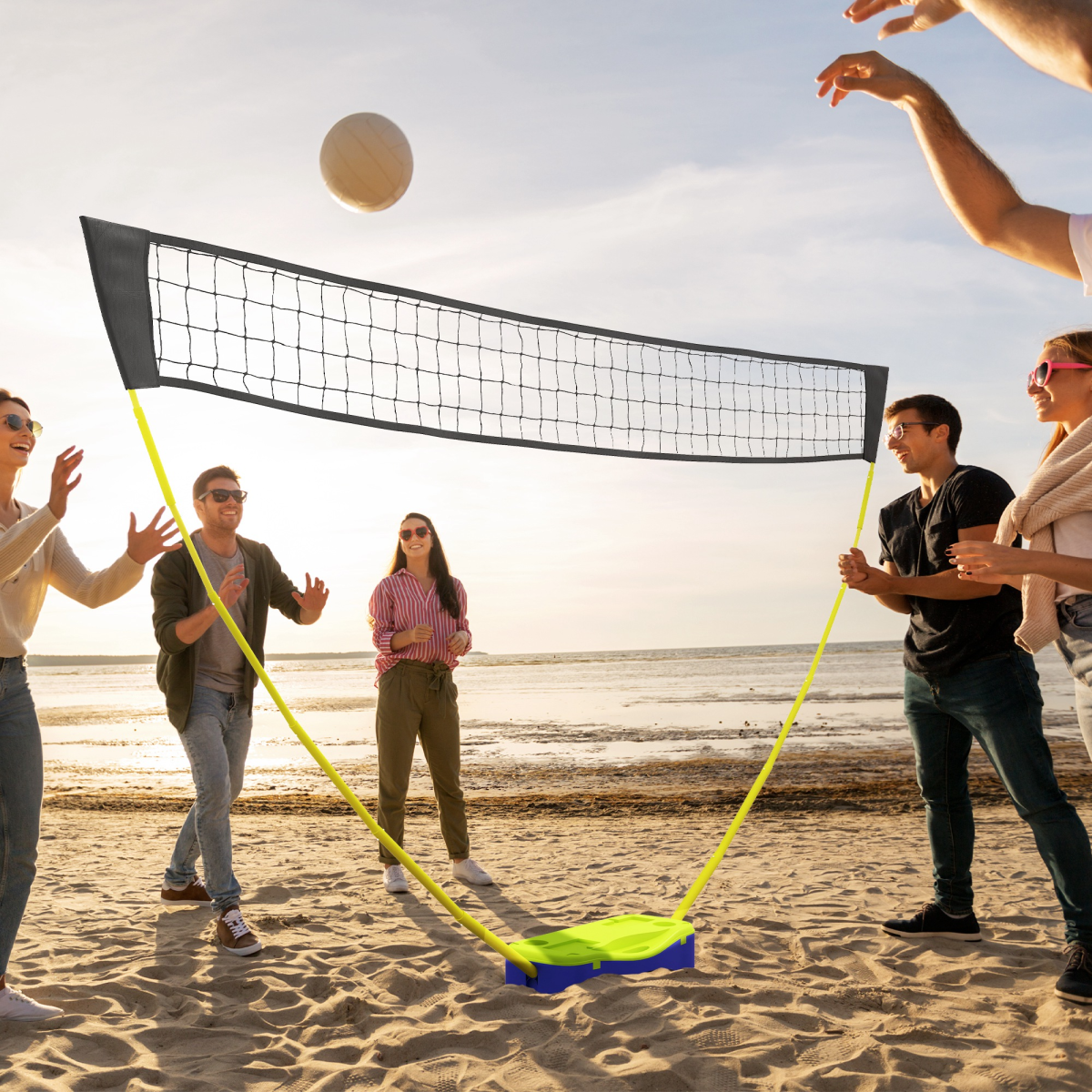 Portable beach volleyball net with bright yellow poles, perfect for van life adventures and outdoor fun