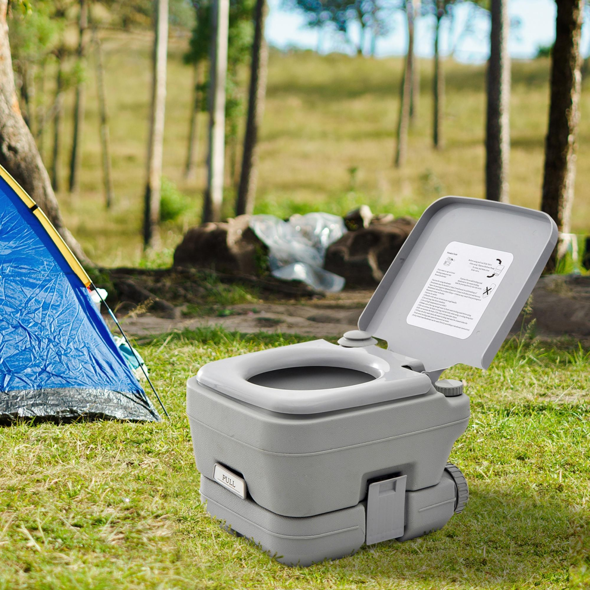 Portable camping toilet for van life and outdoor adventures, shown beside a tent in a forest setting.