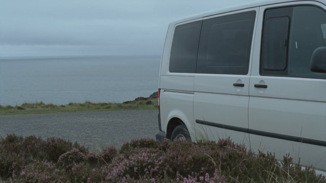 Campervan travelling through rugged UK coastal landscapes in moody grey weather, capturing the freedom of van life, scenic road trips, remote countryside adventures and slow travel across Britain’s wild coastline.