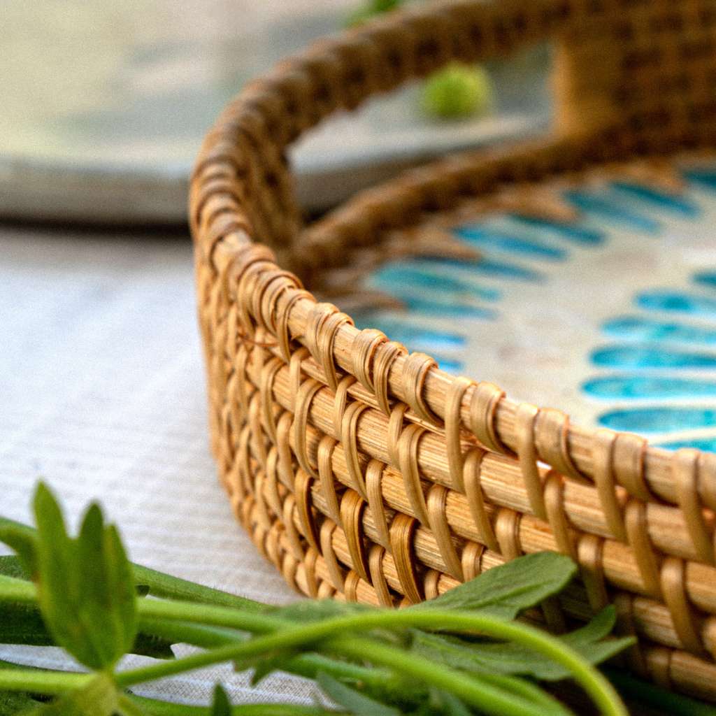 Woven rattan tray with blue pattern, perfect for van life essentials and outdoor adventures
