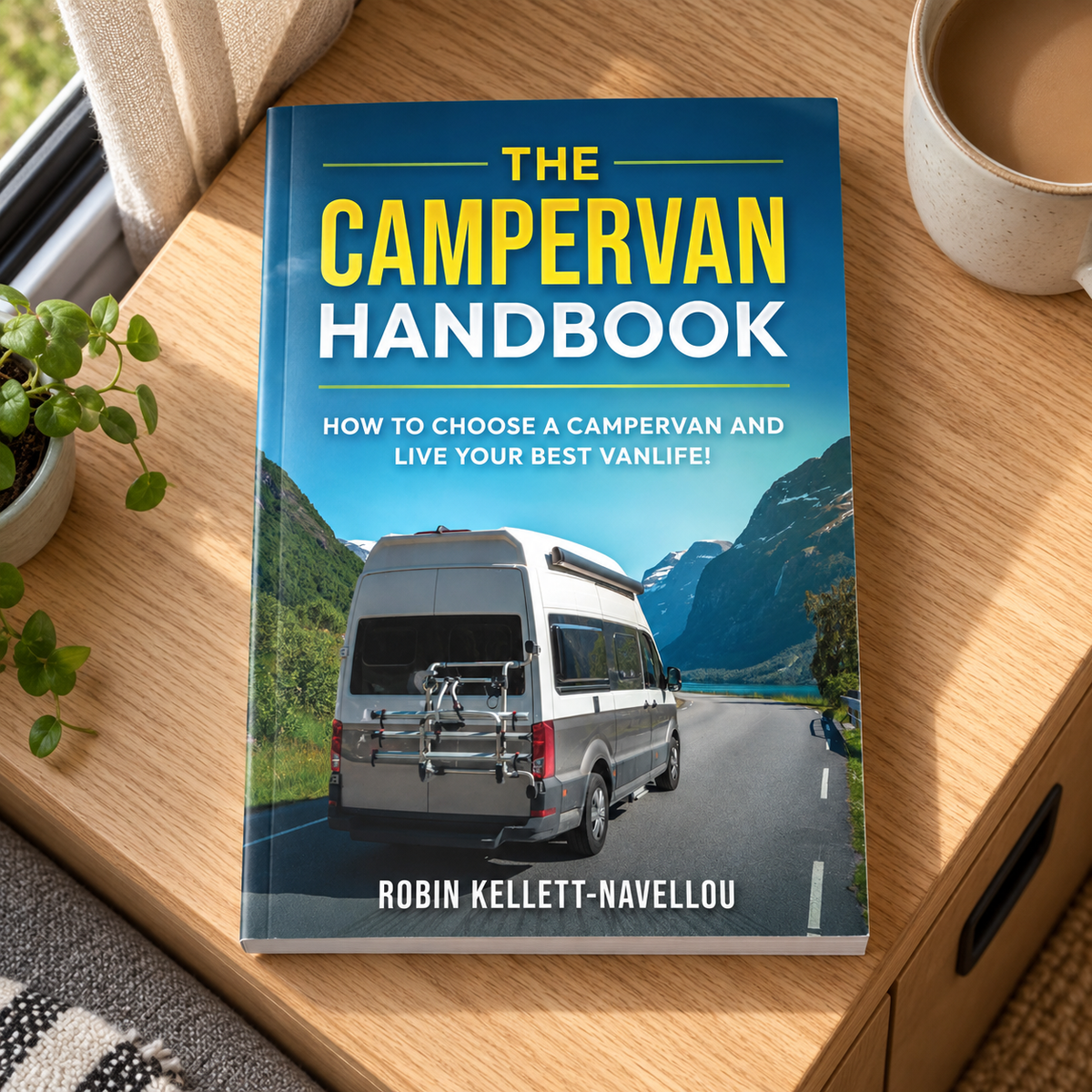 The Campervan Handbook – book on a wooden campervan table