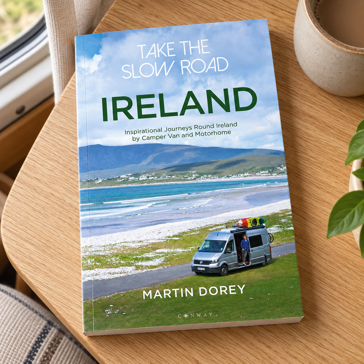 Take the Slow Road: Ireland – book on a wooden campervan table