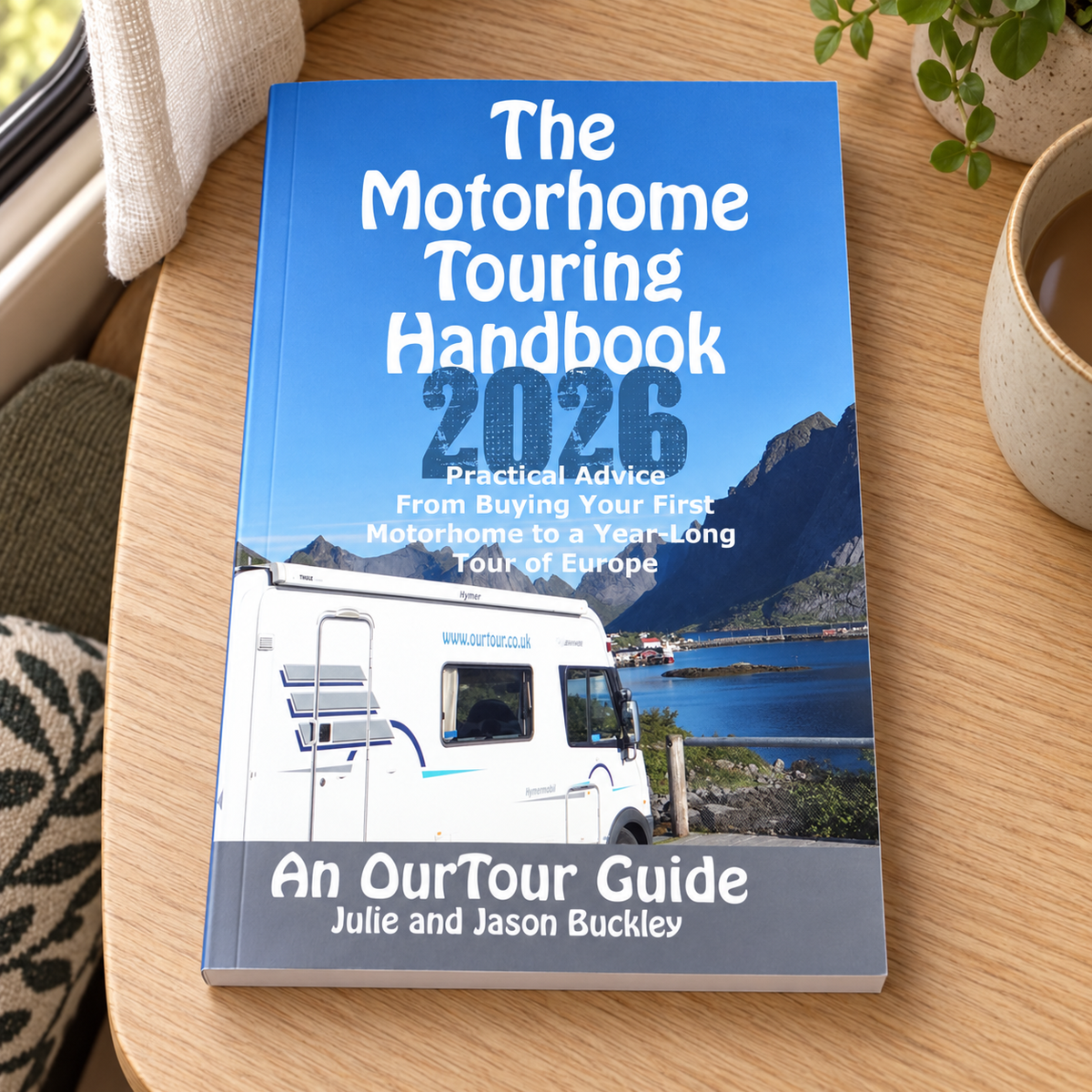 The Motorhome Touring Handbook – book on a wooden campervan table