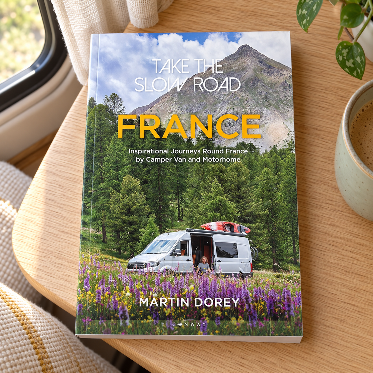 Take the Slow Road: France – book on a wooden campervan table
