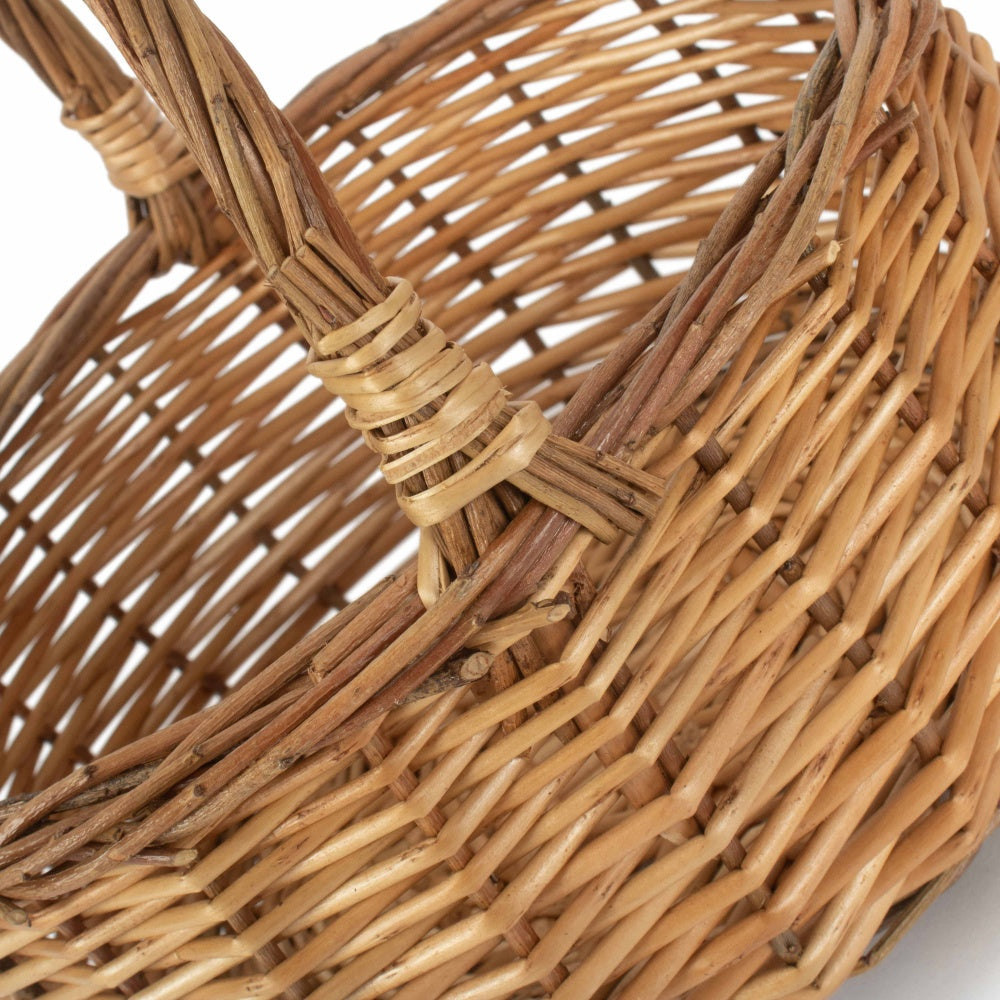 Handwoven wicker basket with sturdy handles, perfect for picnics or van life essentials