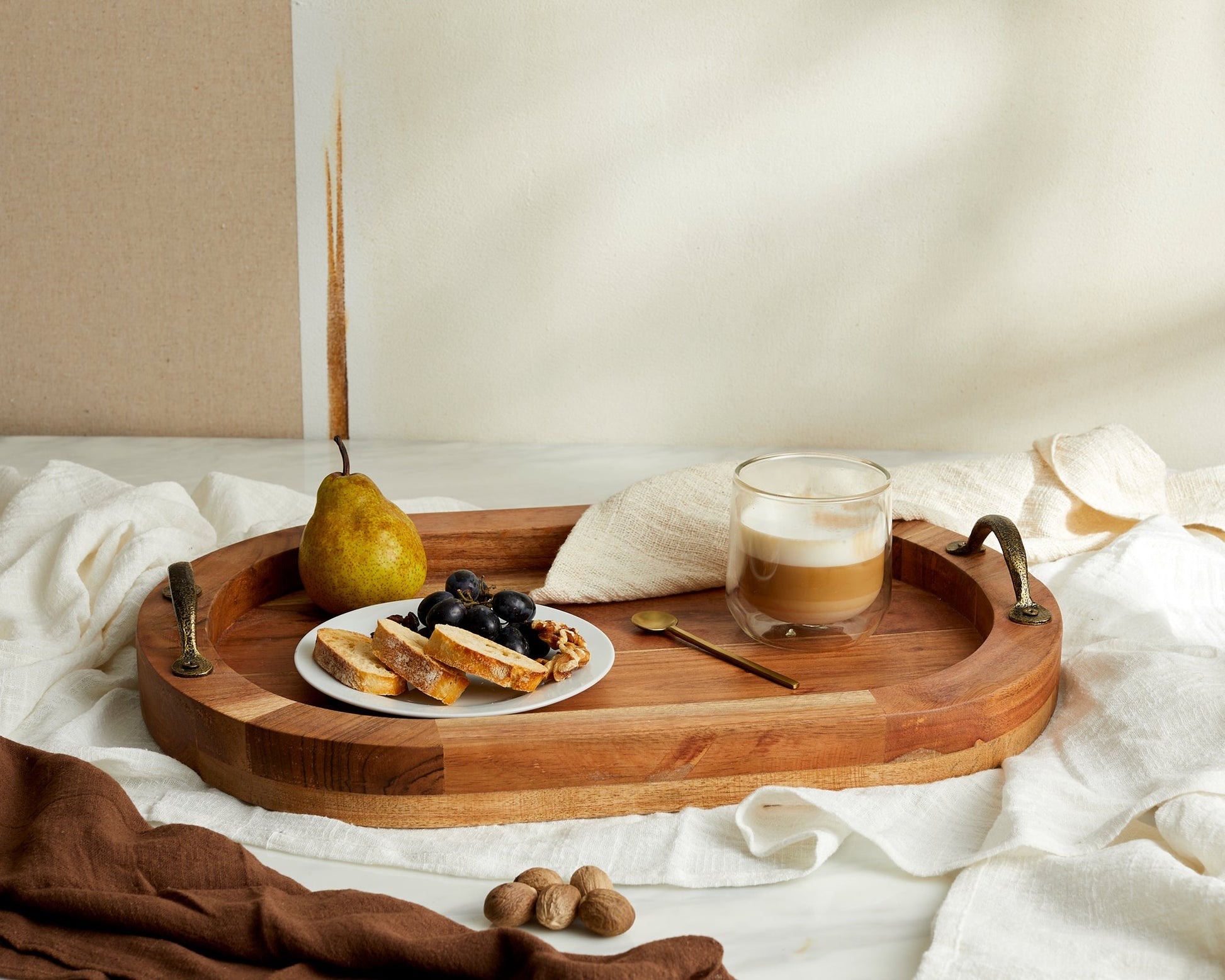 Wooden serving tray with coffee, fruit, and bread for van life breakfast essentials